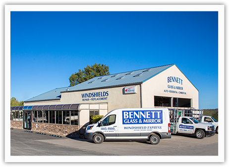 Bennett Glass and Mirror glass shop in Prescott Arizona with service vans parked in front