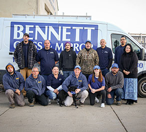 Bennett Glass and Mirror employees standing in a group outside glass shop