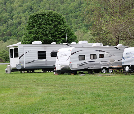 group of various make and model RVs in campground